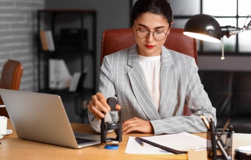 A remote online notary uses her stamp on a document.